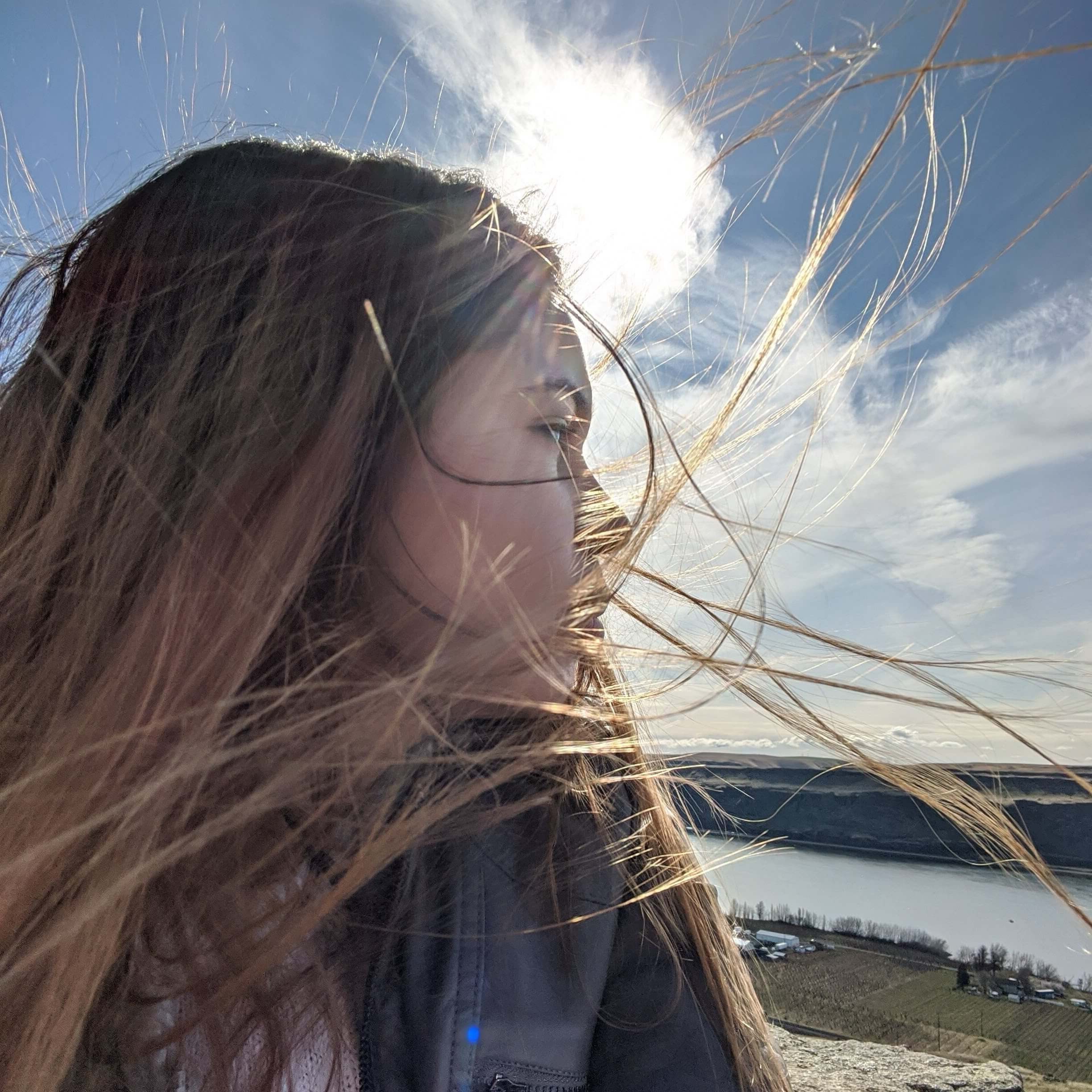 Profile picture of Juanita Samborski, looking over shoulder at a river.